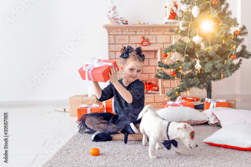 Holidays and childhood concept - Portrait of little happy cute girl with Christmas present