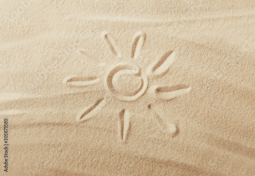 sun drawing on the beach sand