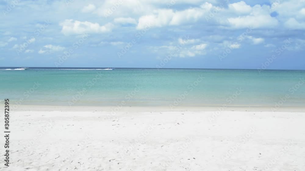 Tropical sandy beach at andaman sea with cloudy blue sky. scenery of karon beach with speed boats are running under sunlight during summer in phuket. Thailand. Tropical sandy beach at andaman sea with cloudy blue sky. scenery of karon beach with speed boats are running under sunlight during summer in phuket. Thailand.