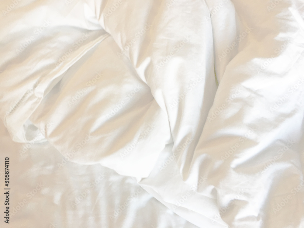 Top view of bedding sheets and blanket texture abstract background with sunlight in the morning