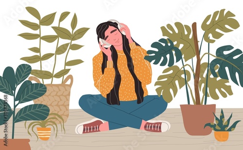 Young woman in headphones listening to music.
