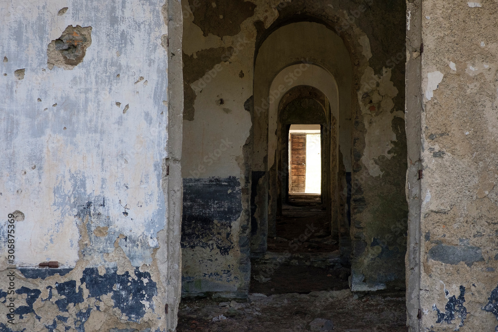 Corridors inside a large dilapidated military barracks in the Italian Alps