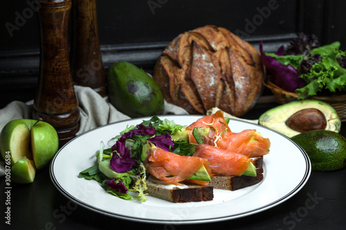 smoked salmon bruschetta with avocado and cream cheese served with salad