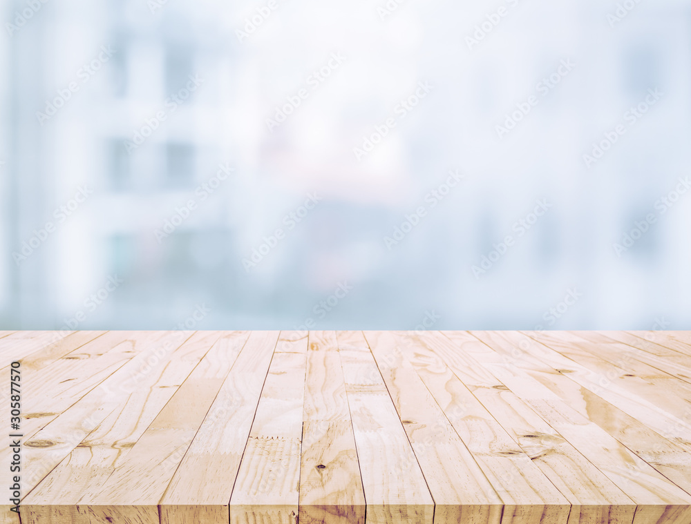 Selective focus of wood table top on white wall glass (big window) background Selective focus of wood table top on white wall glass (big window) background