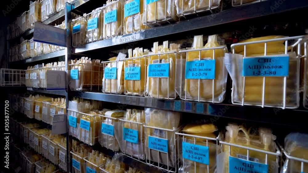 Many bags with yellow plasma stored on a rack at a clinic. Many bags with yellow plasma stored on a rack at a clinic.