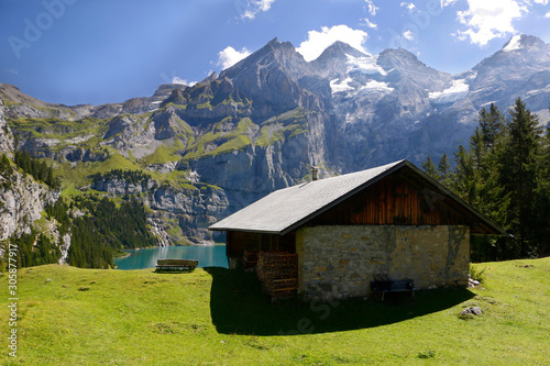 Idyllic hut on swiss alps lake