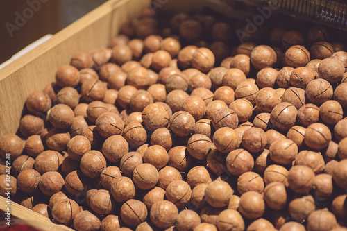 Foto Macadamia nuts on a market counter. Inshell Macadamia Nuts