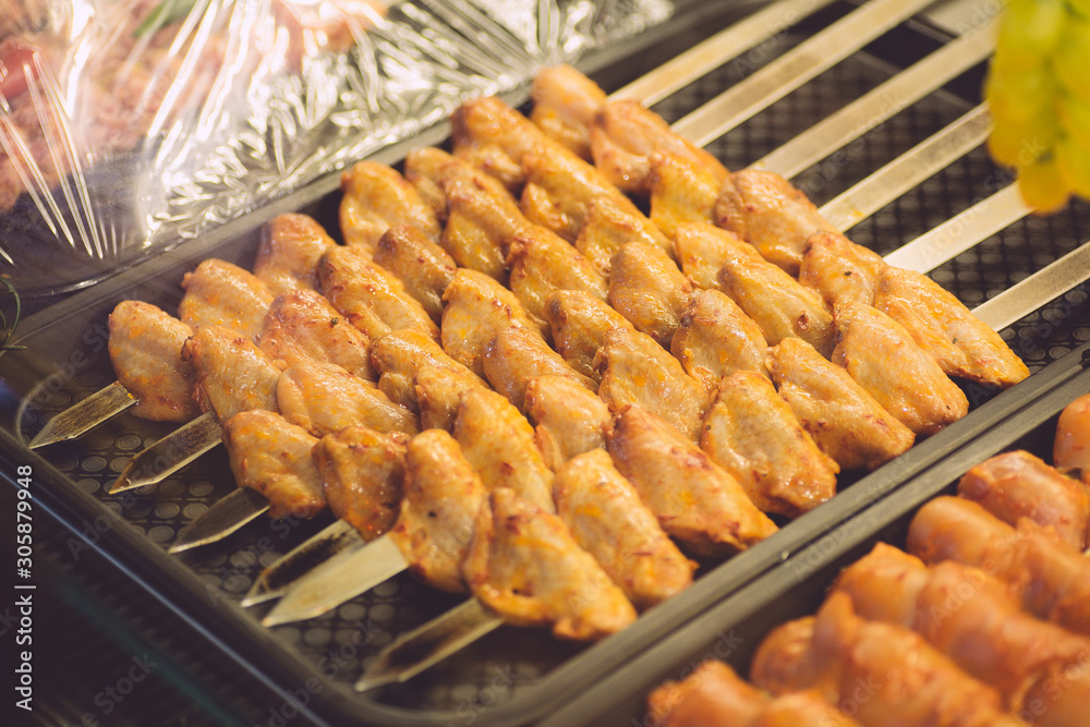 Chicken kebab in the kitchen of an oriental restaurant. Kebab with chicken wings. Oriental and Muslim Street Food