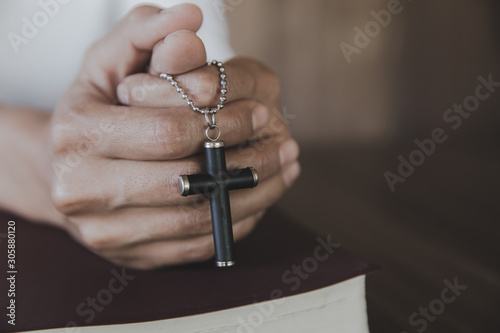 Human hands holding a cross holy and prayed for blessings from God, Amour Worship God concept.