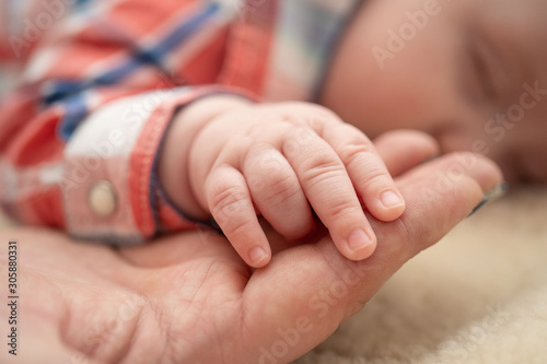 Dziecięca dłoń w rękach rodzica
