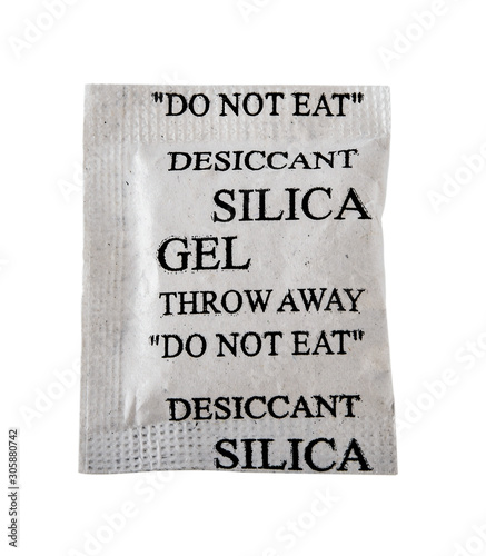 Close up silica gel or desiccant in paper bag isolated on white background