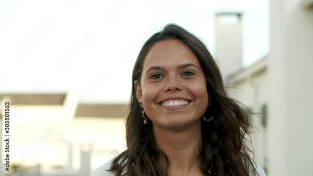 Closeup shot of beautiful laughing woman. Attractive young lady with long hair looking at camera. Happiness concept Closeup shot of beautiful laughing woman. Attractive young lady with long hair looking at camera. Happiness concept