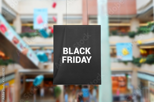 Black Friday poster, flag hanging at the shopping mall. Shopping center in background.