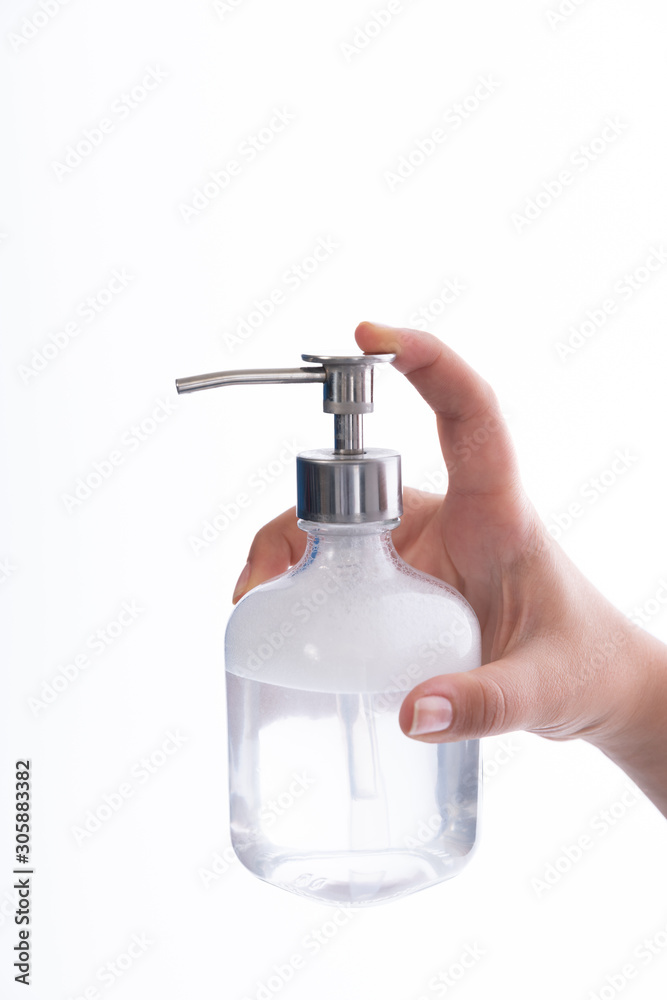 Finger pushing the soap dispenser on white background Finger pushing the soap dispenser on white background