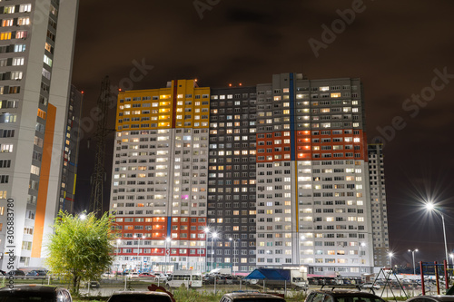 Public residential condominium building complex at night. House lights photo