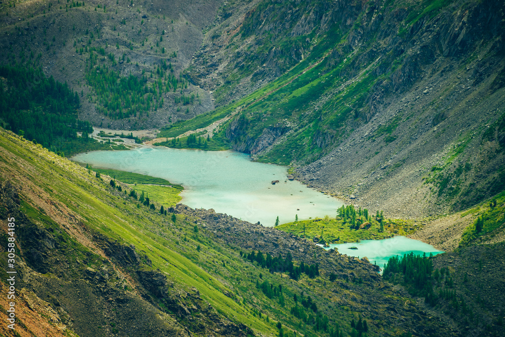 Naklejka premium Aerial spectacular view to scenic valley with two beautiful mountain lakes, conifer forest and rocky mountains. Amazing atmospheric highland landscape. Wonderful majestic wilderness nature scenery.