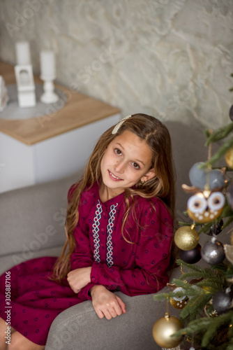 little girl decorating christmas tree