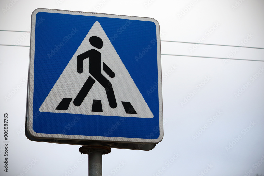 Blue road crossing sign on white sky background Blue road crossing sign on white sky background