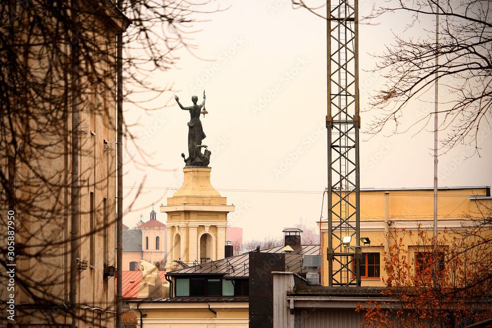 Fototapeta premium Vilnius city energy museum woman with lantern elektra statue from behind