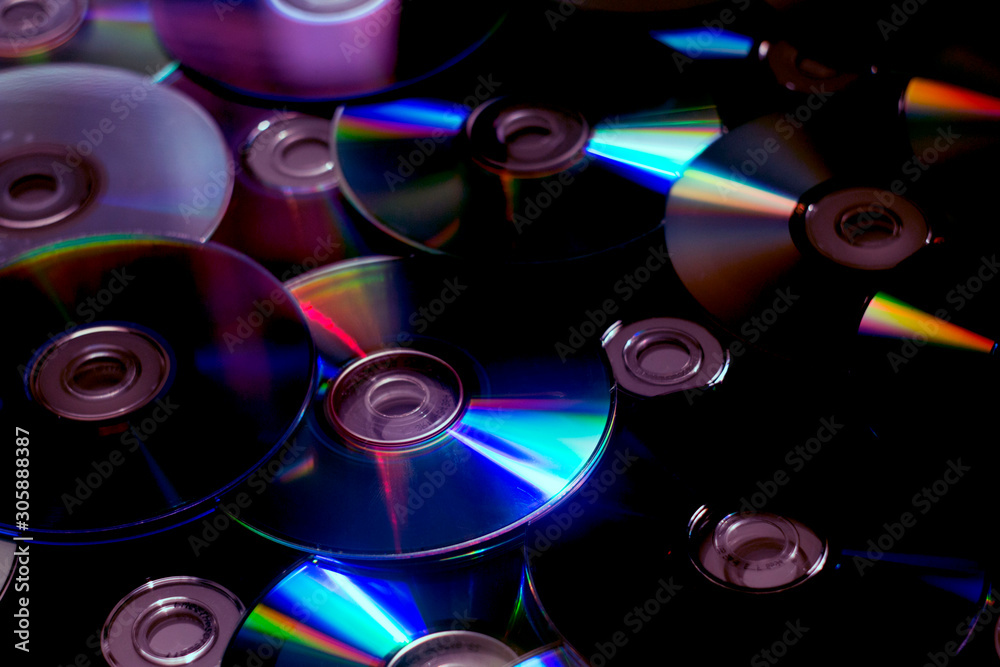 Blue red yellow green pink neon highlights on CD. Blue red yellow green pink neon highlights on CD.
