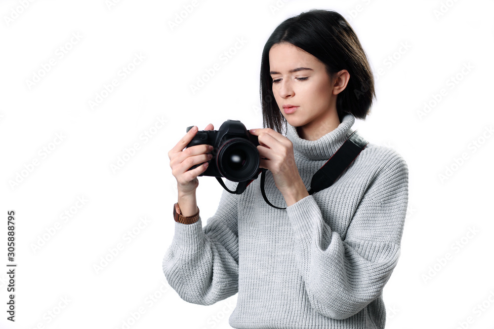 beautiful woman holding a photo camera. Isolated over white background beautiful woman holding a photo camera. Isolated over white background