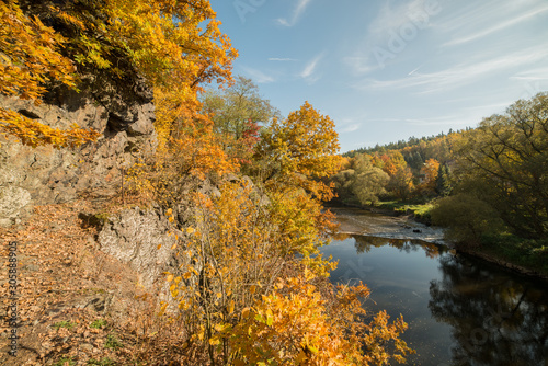 rocks over a river in autumn