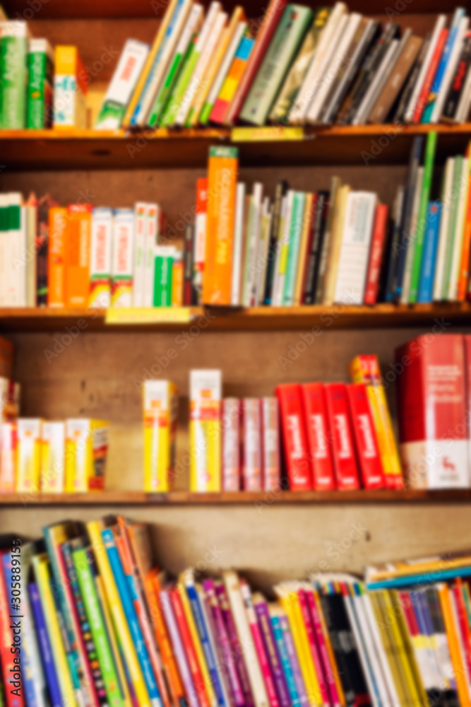 Books in rows on shelves. Blur Vertical. Background. Space for text. Books in rows on shelves. Blur Vertical. Background. Space for text.