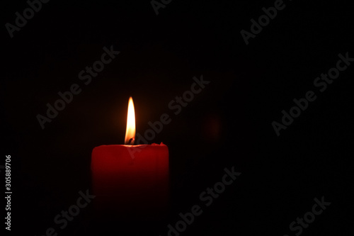Candle flame on black background.