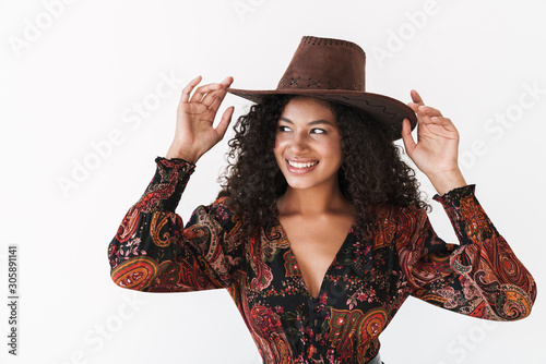 Beautiful cheerful young woman wearing cowboy hat photo