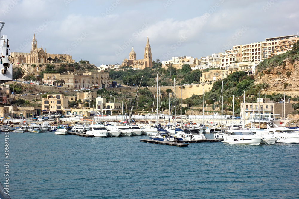 View from the sea of the port of Gozo with the Parish Church of Our Lady of Loreto, Roman Catholic neo-gothic parish church
