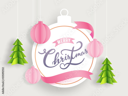 Calligraphy Merry Christmas text in bauble shape frame decorated with paper cut Xmas tree and ornament balls on white background. Can be used as greeting card design.