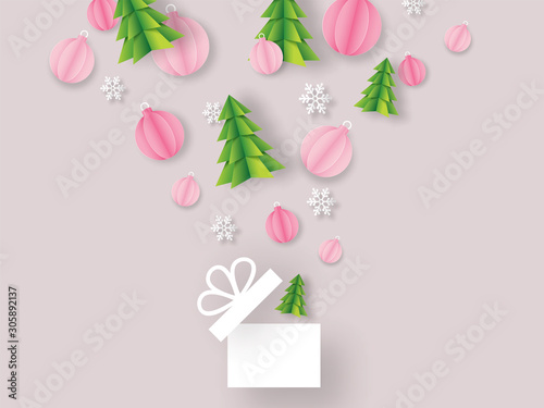Origami paper cut Xmas tree with baubles and snowflakes flying from open surprise gift box on pink background for Merry Christmas celebration greeting card design.