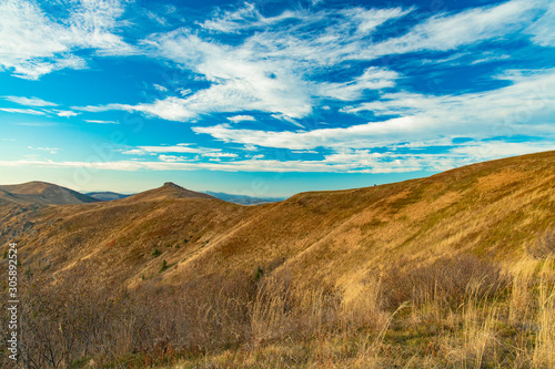 Carpathian mountain ridge scenery landscape view trekking route in clear weather day time and vivid blue sky cloudscape background  © Артём Князь