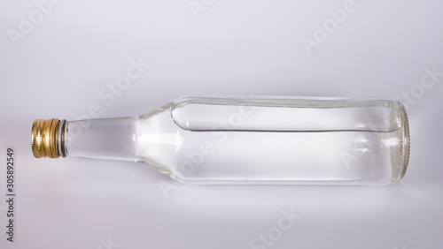 Bottle with a clear liquid, vodka on a white background