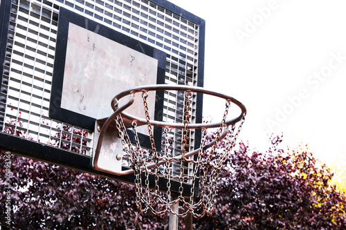 Basketball hoop with metal chains and backboard in a park. Healthy lifestyle. For play street basketball game
