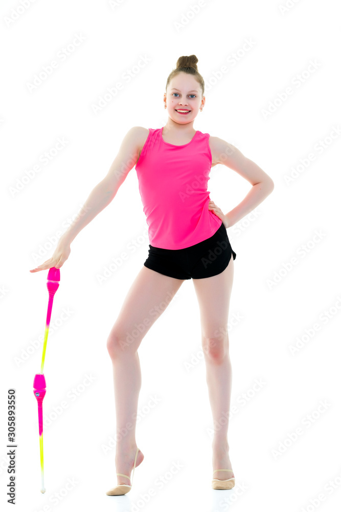 A girl gymnast performs exercises with a mace. A girl gymnast performs exercises with a mace.