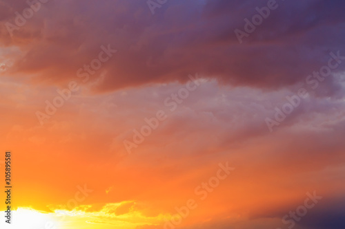 Fantasy abstract background, Gold sunlight on colorful sky and moving red purple blue cloud before sunset © paahboobkk