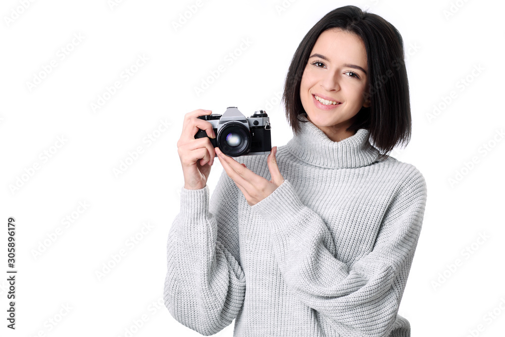Portrait of a smiling young woman holding retro camera Portrait of a smiling young woman holding retro camera
