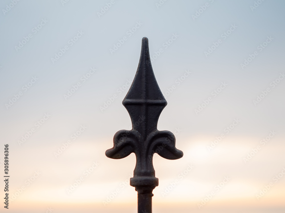 Forged detail of a fence ornament against the sky Forged detail of a fence ornament against the sky