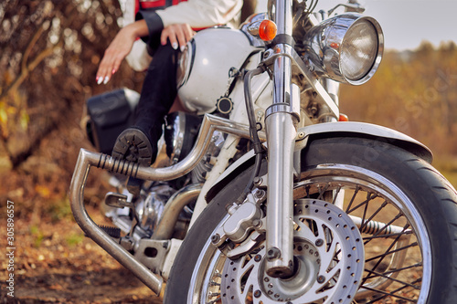 close-up front of a motorcycle with a woman sitting on it