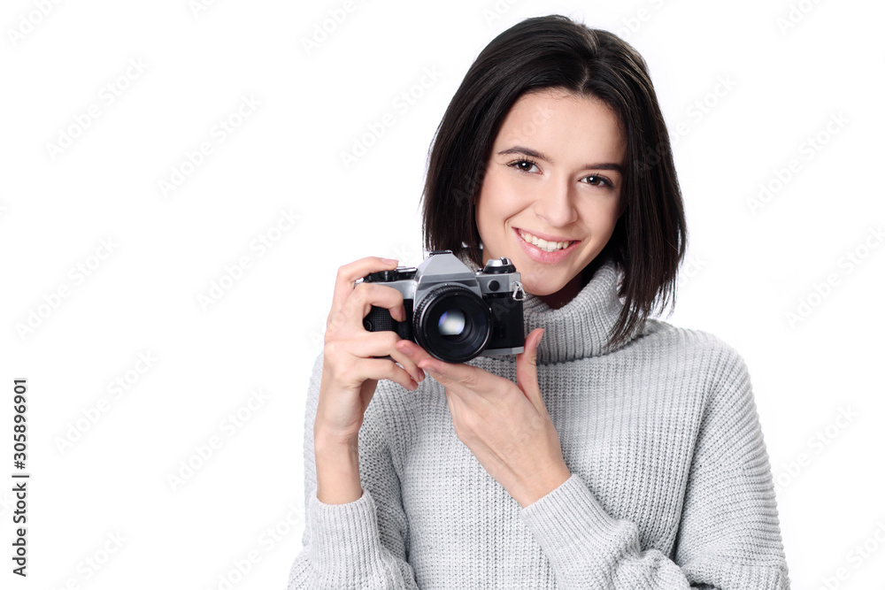 Portrait of a smiling young woman holding retro camera Portrait of a smiling young woman holding retro camera