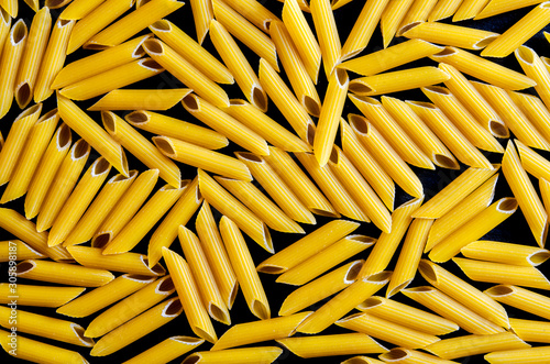 Background of Penne on a black stone background with copy spase