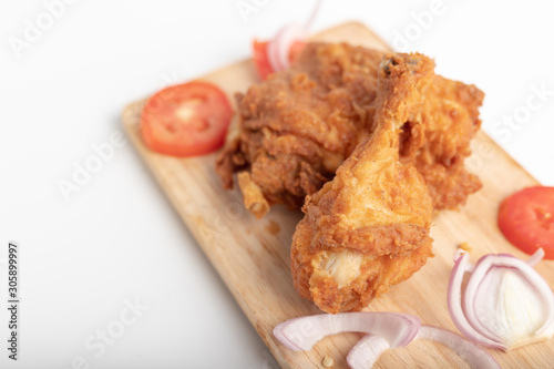 Chicken fried on the wooden cutting board