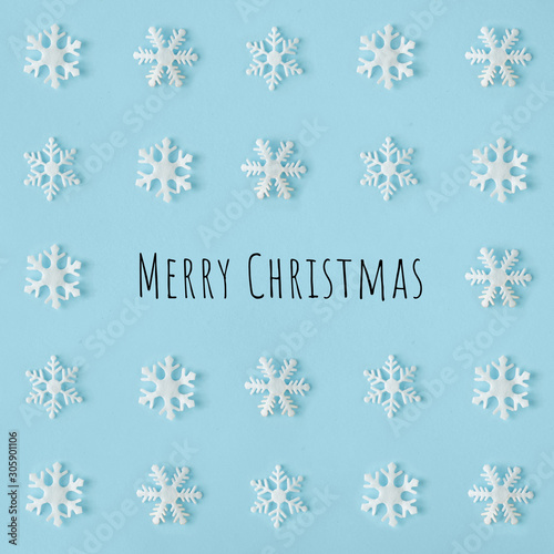 Creative snowflakes pattern with bright blue background. Minimal winter flat lay Christmas concept. Merry Christmas