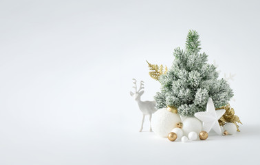 Christmas or New Year layout with white snowy Christmas tree and golden Christmas decoration. Bright  Holiday background.