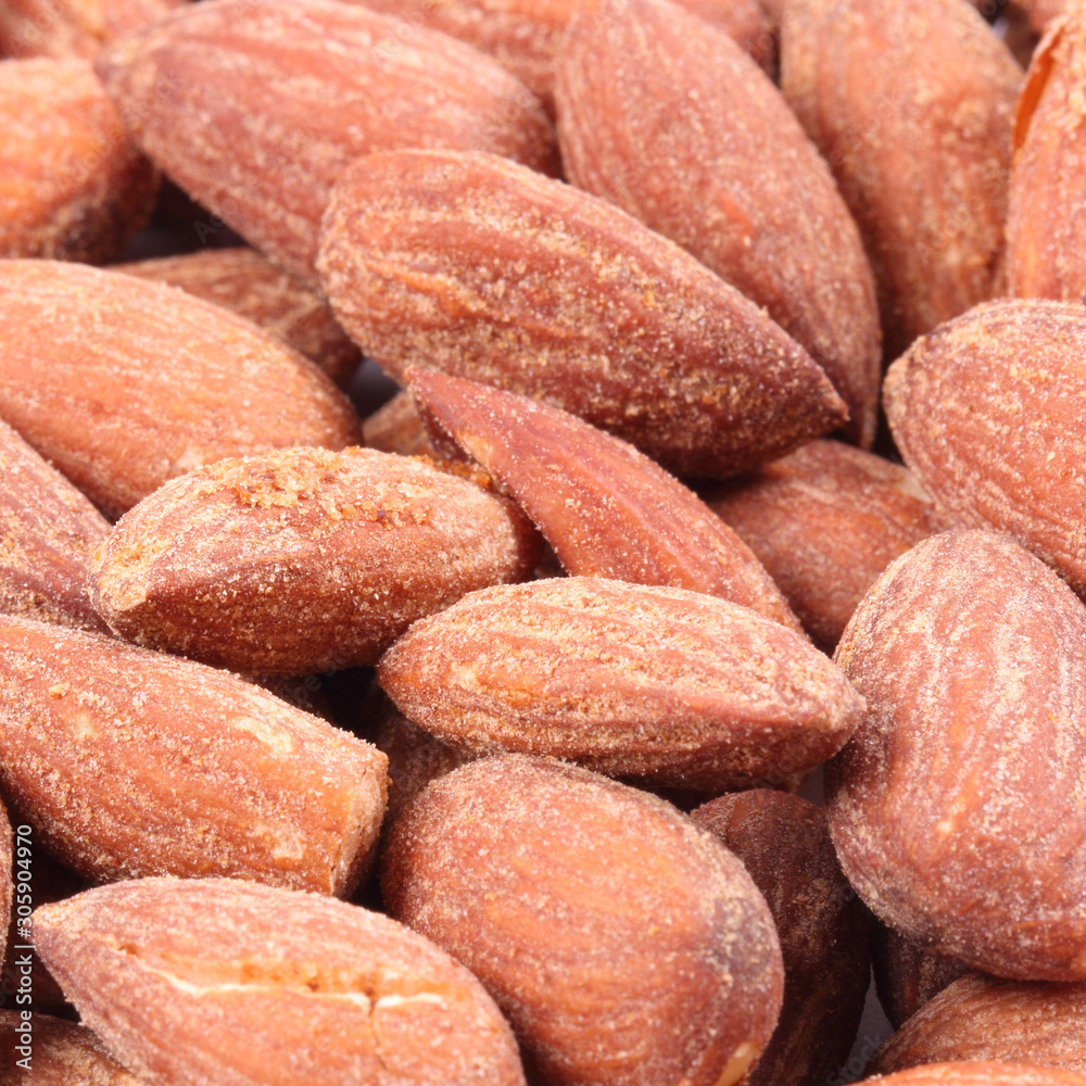 Pile of almonds close-up as background. Pile of almonds close-up as background.
