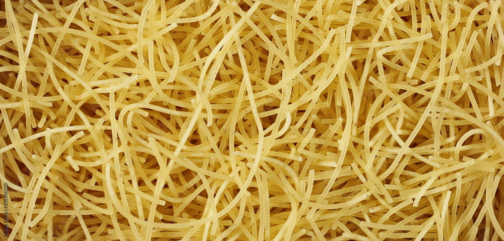 Dry, raw egg pasta noodles background and texture Dry, raw egg pasta noodles background and texture
