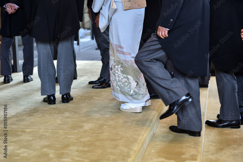 Fototapeta premium Men wearing the same tail coats at an official ceremony