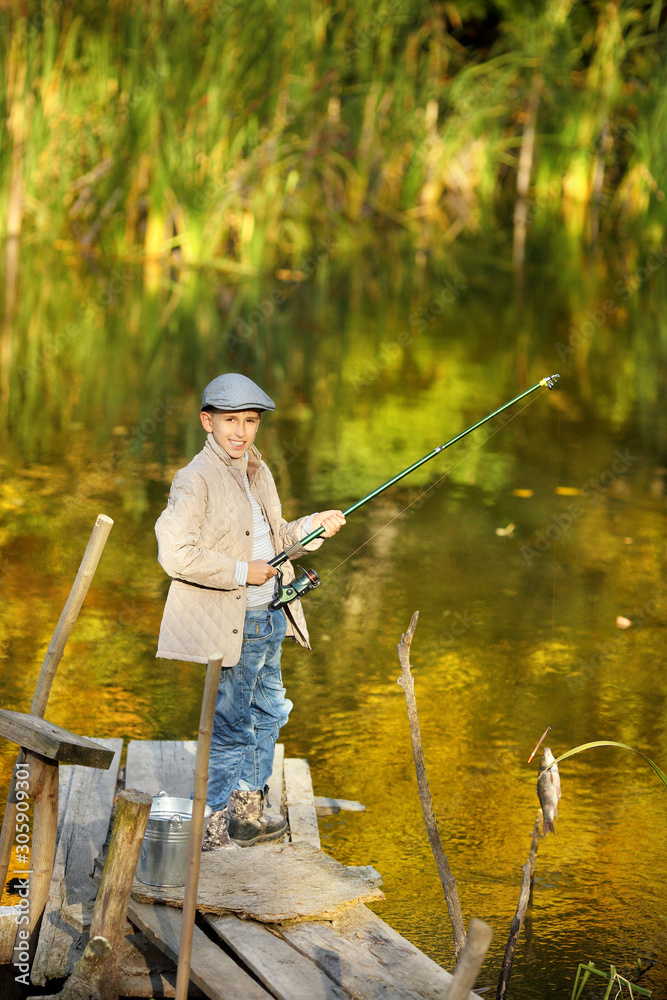 Boy Catching a Fish from wooden dock. Boy Catching a Fish from wooden dock.
