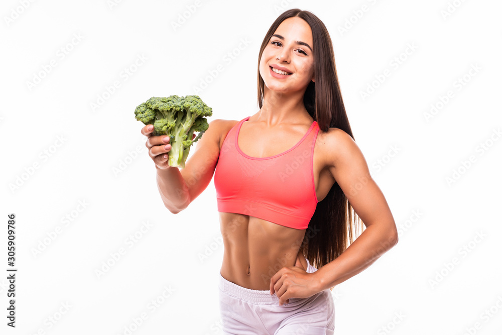 Fitness woman holding broccoli isolated on white background Fitness woman holding broccoli isolated on white background